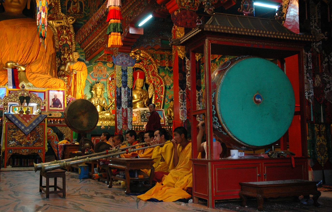 Tibetan_Band_playing_large_drums_Buddha_and_bodhisattva_statues_shrine_room_Sakya_Lamdre_Boudha_Kathmandu_Nepal.jpg